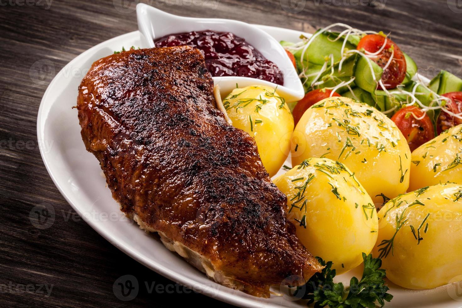Barbecued duck fillet, boiled potatoes and vegetable salad photo