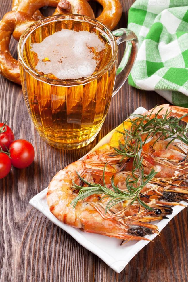 Grilled shrimps, pretzel and beer mug photo