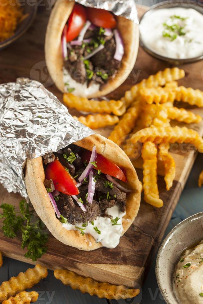 Homemade Meat Gyro with Tzatziki Sauce and French Fries photo
