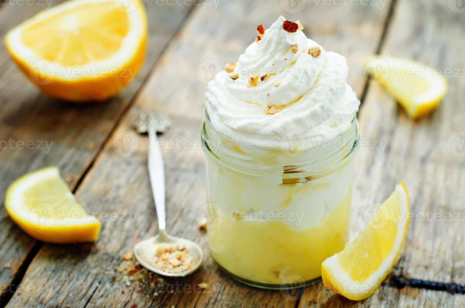 layered dessert with lemon cream, ice cream and whipped cream photo