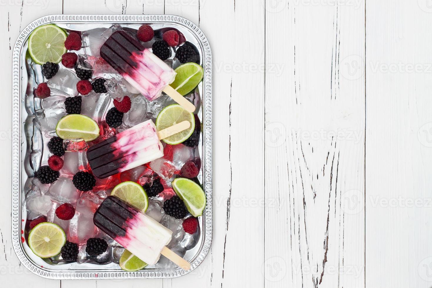 Berry vanilla  popsicles in a vintage silver ice tray photo