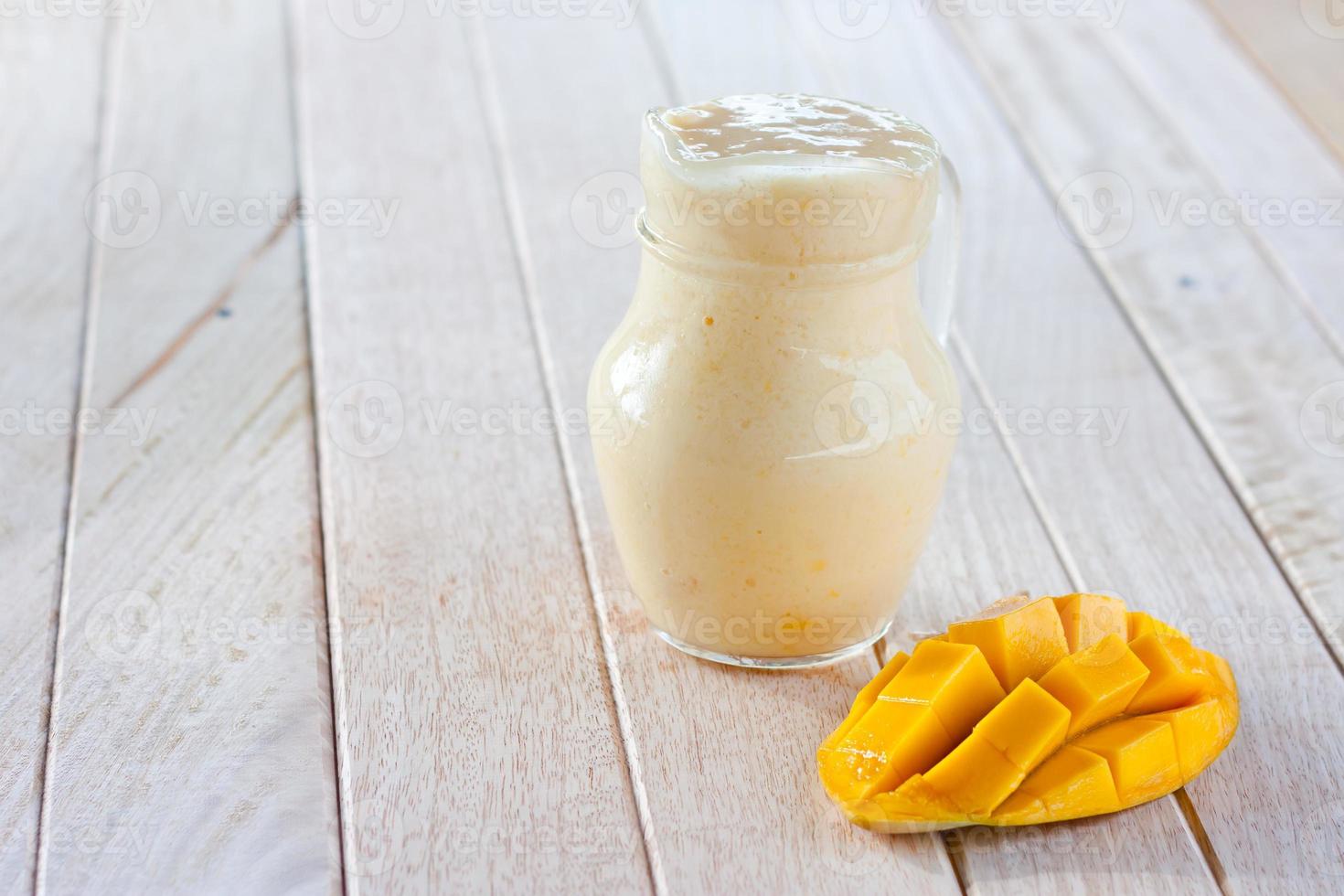mango smoothie on wooden table photo