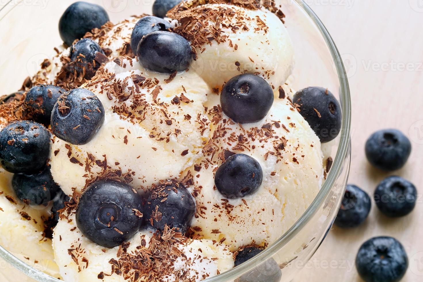 Vanilla ice cream with blueberries and chocolate photo