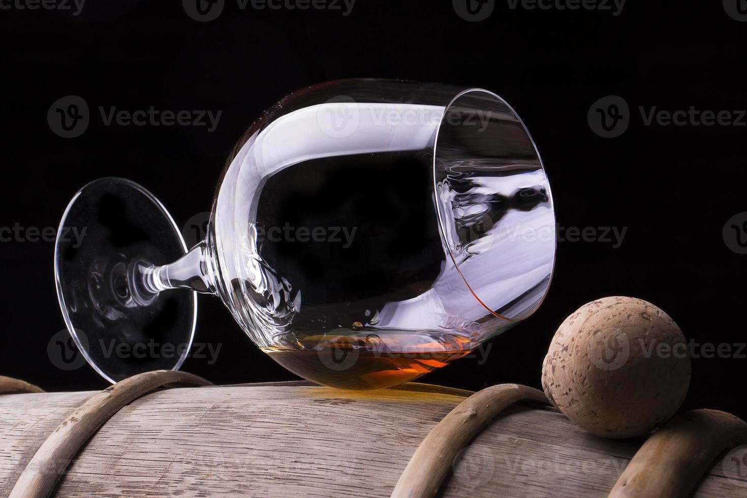 Cognac or brandy on a wooden barrel photo