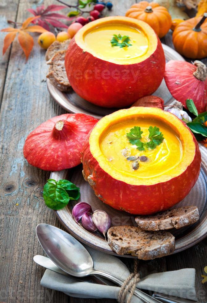 Pumpkin soup on a wooden table photo