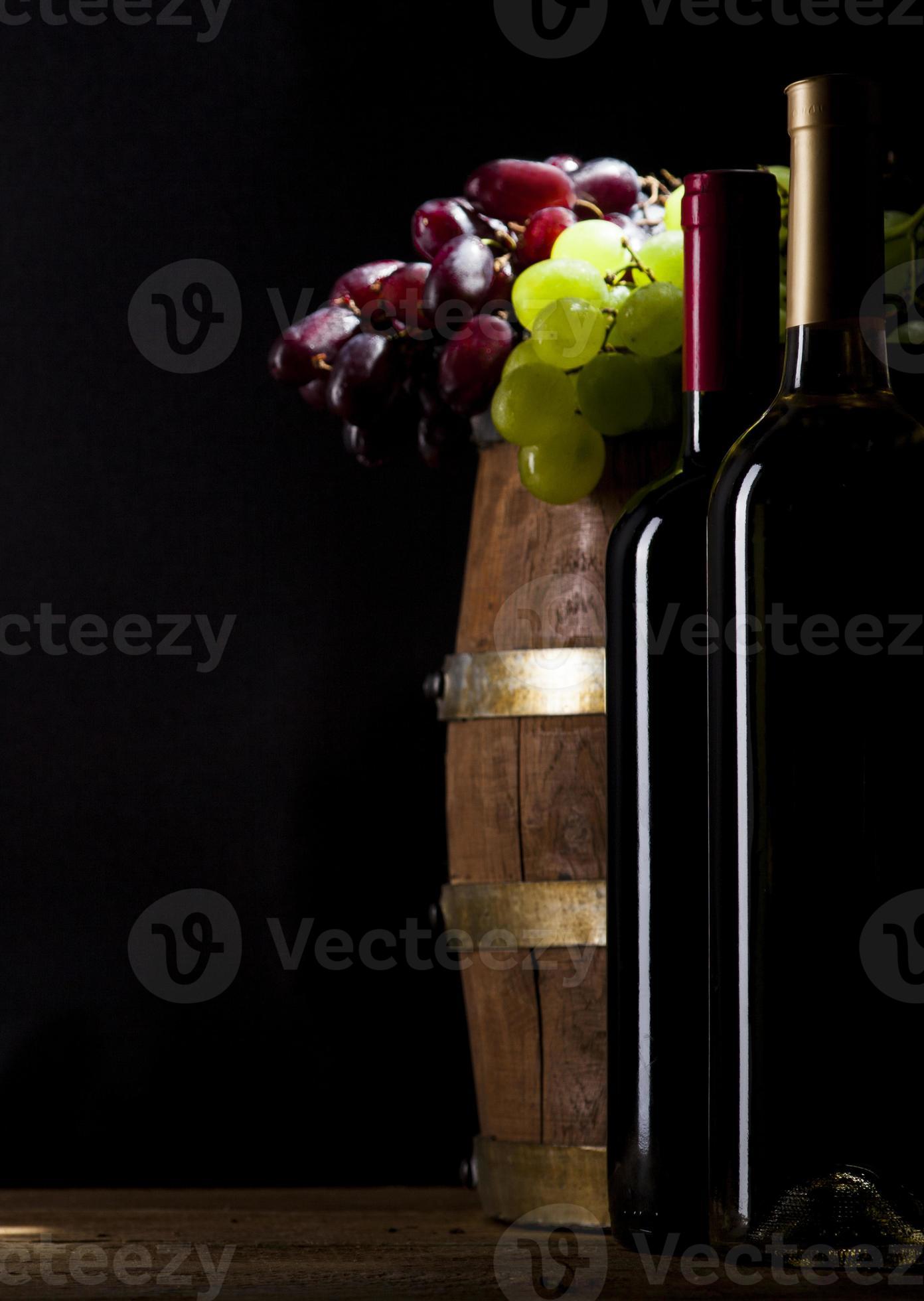 Red and white wine on wooden background photo