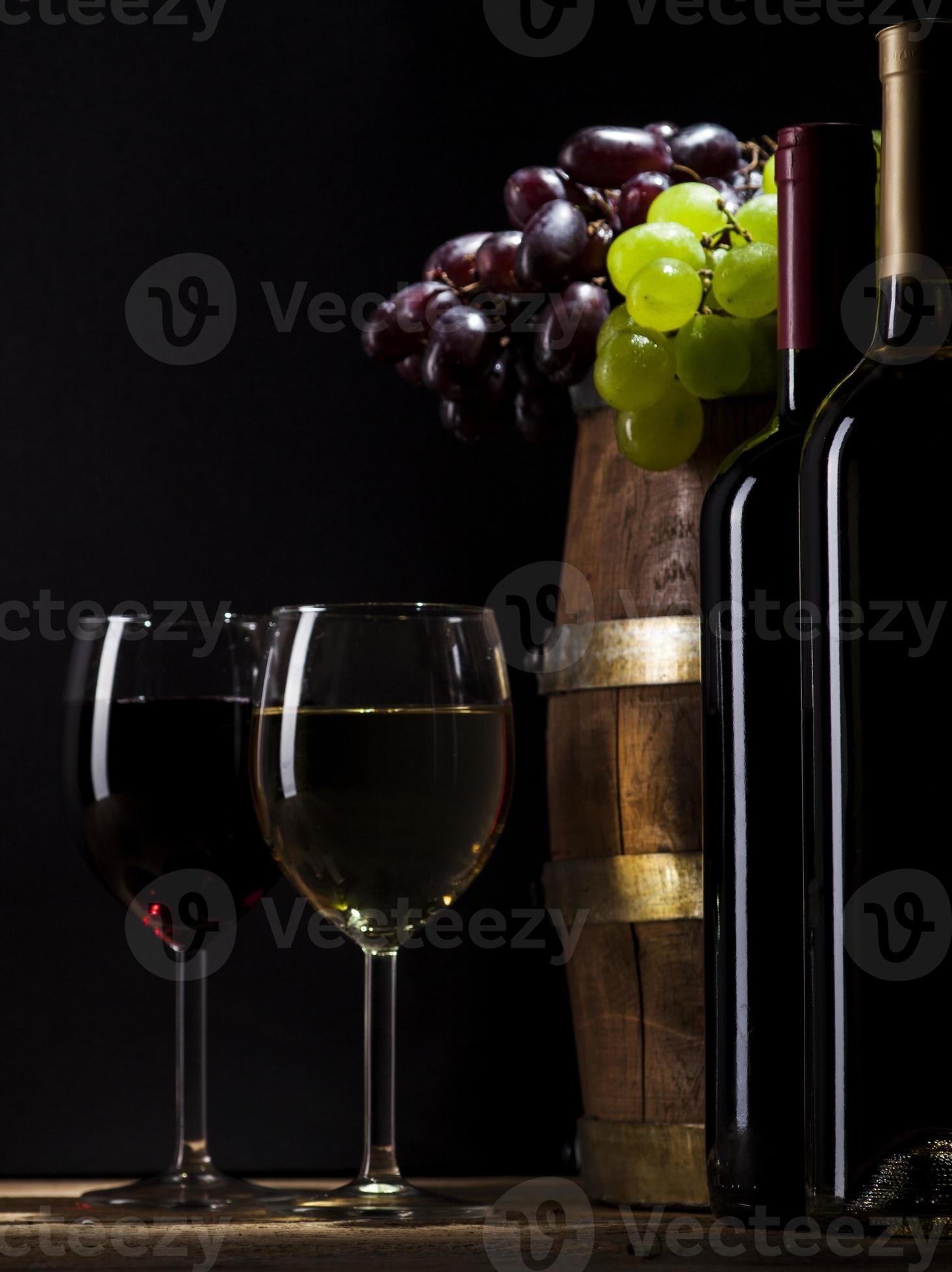 Red and white wine on wooden background photo