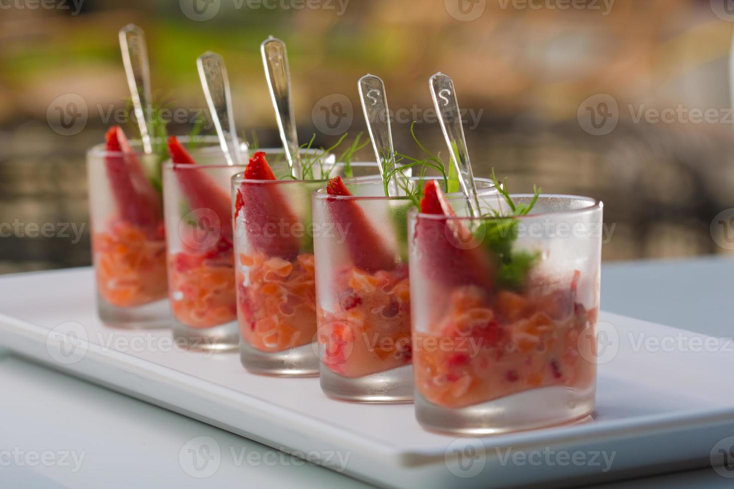 Fresh salad with shrimps, salmon, avocado and strawberries photo