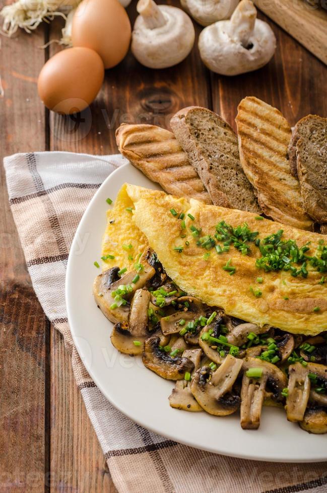 Rustic omelette with mushrooms on chives photo