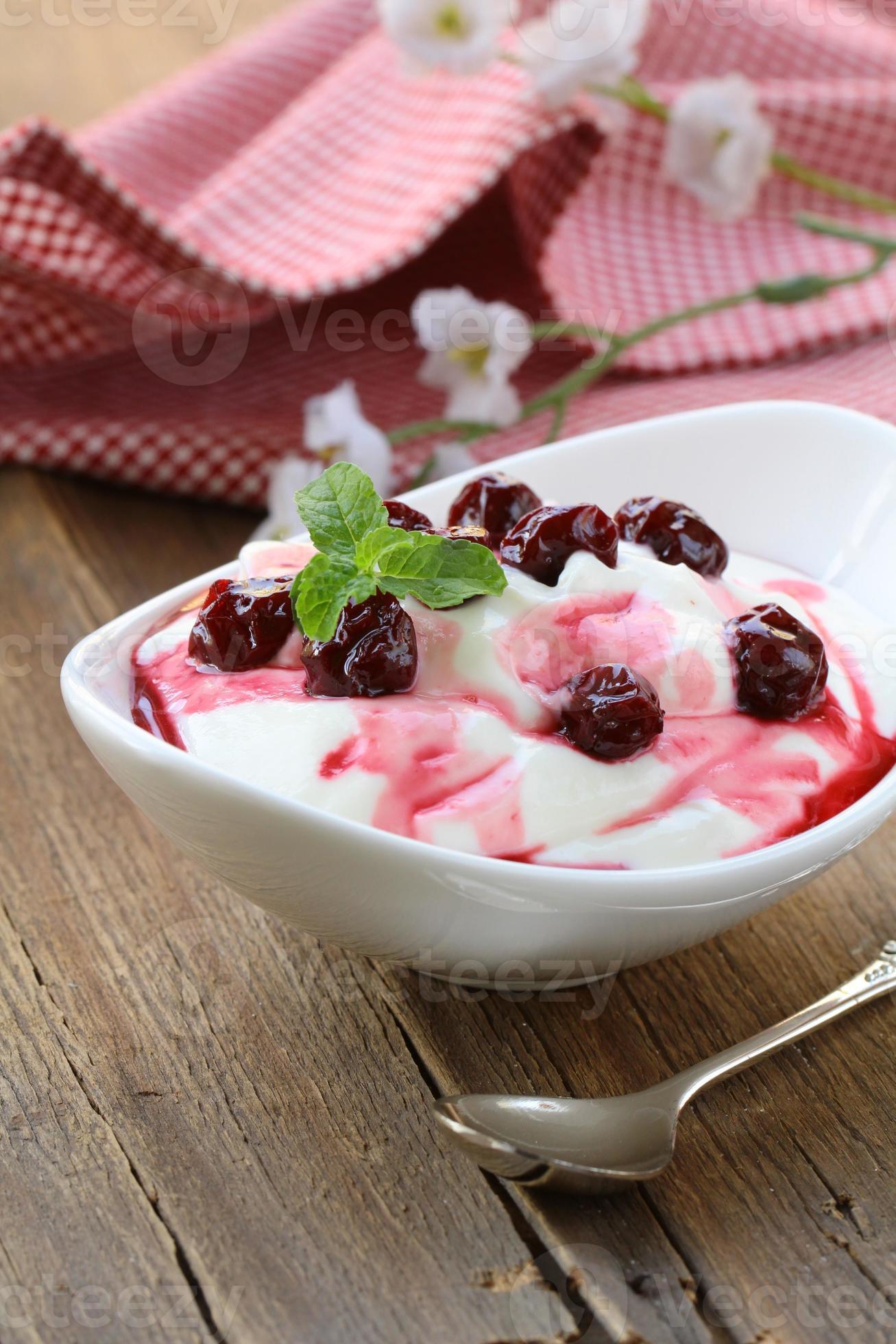dairy dessert with sweet sauce and cherries photo