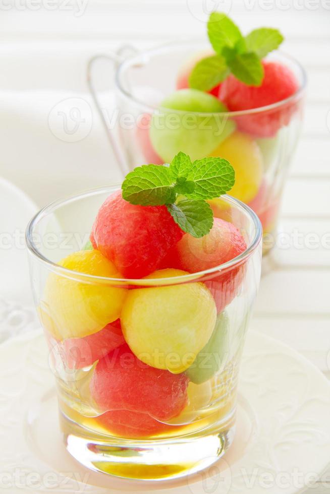 The dessert salad of watermelon and cantaloupe with honey. photo