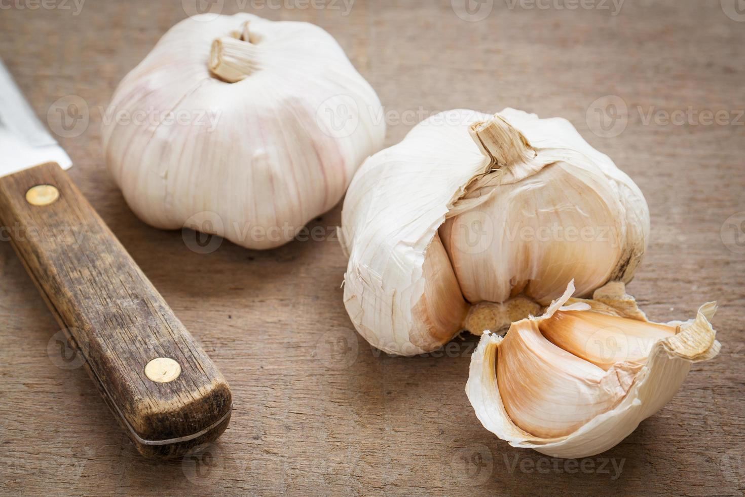 Garlic on wooden table photo