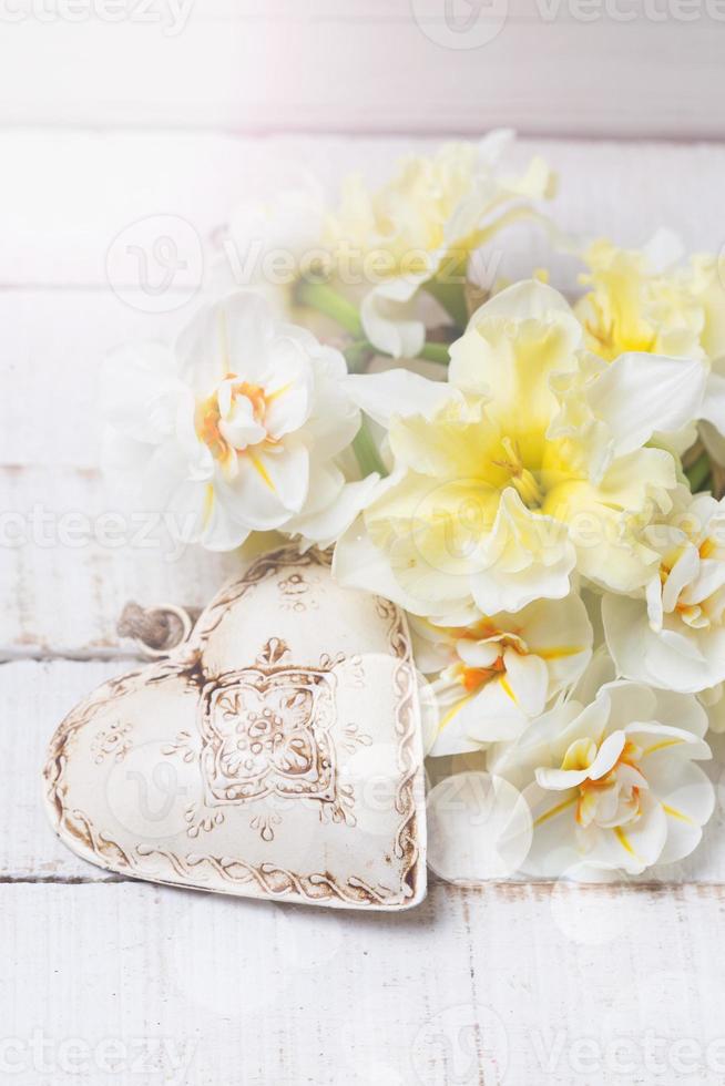 Background with fresh daffodils and heart photo