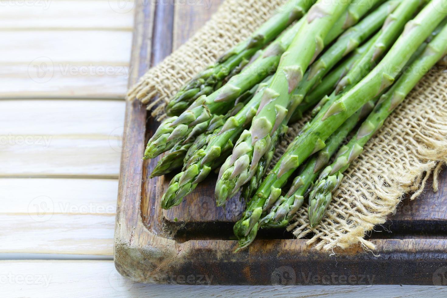 fresh green organic asparagus on a wooden background photo