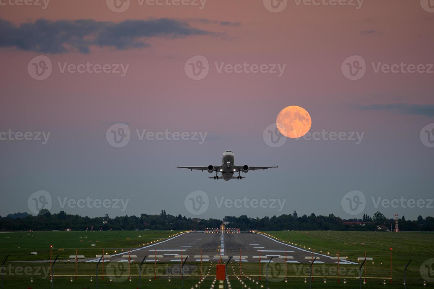 Plane take-off under the full moon photo