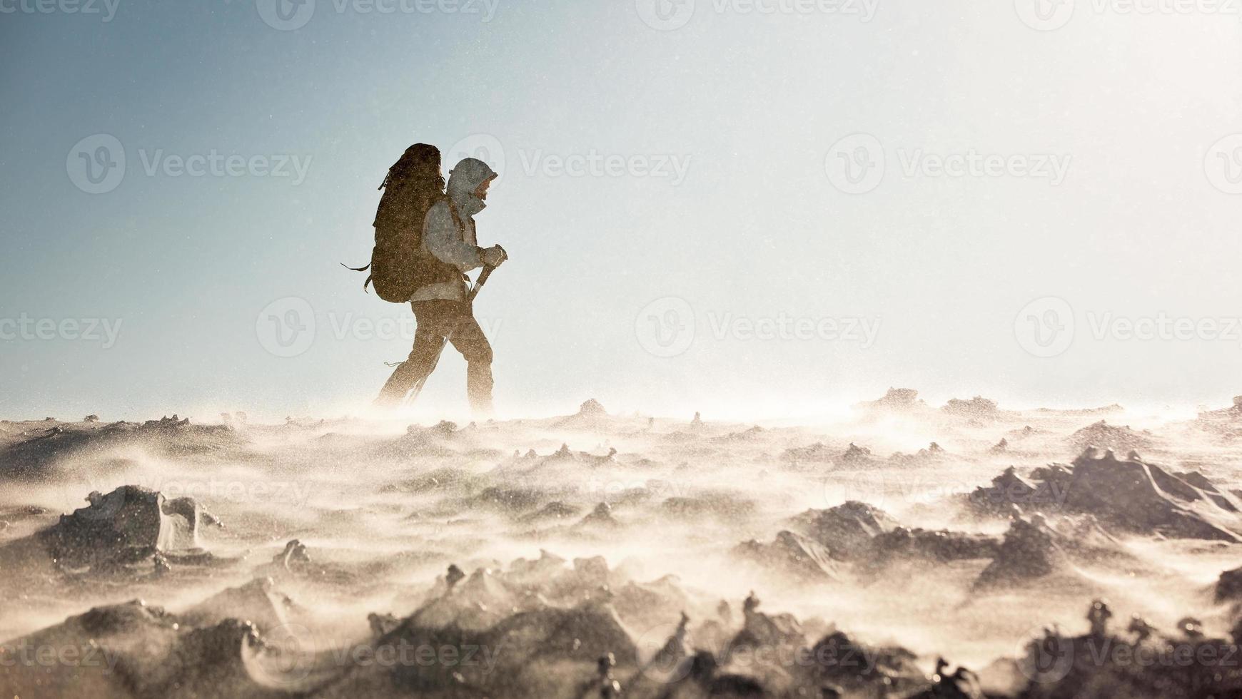 Hiker in winter mountains photo
