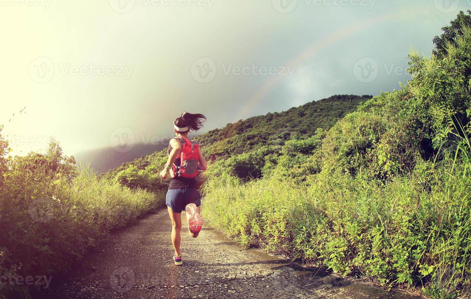 young fitness woman trail runner running on seaside mountain photo