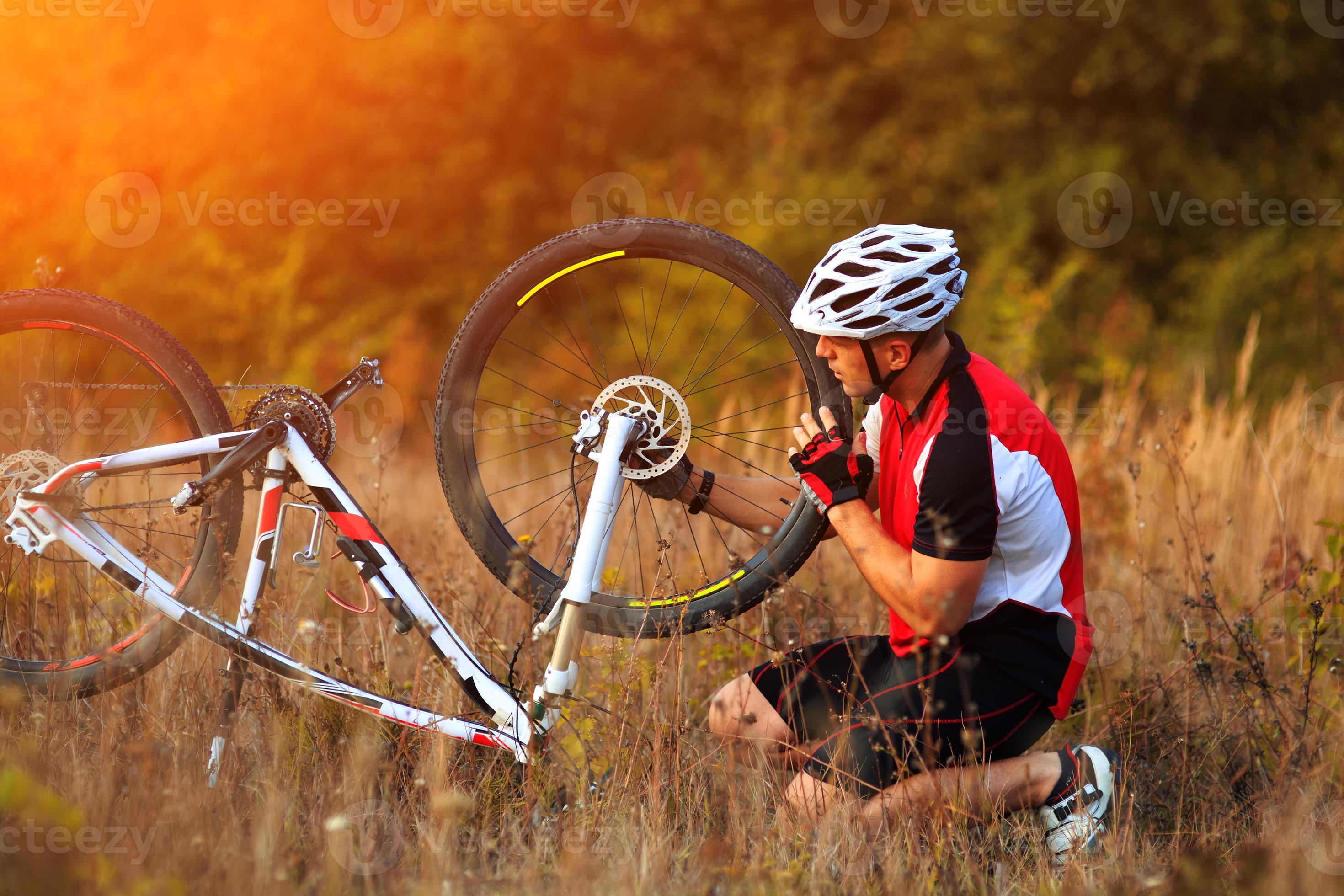 hombre reparando su bicicleta de montaña foto