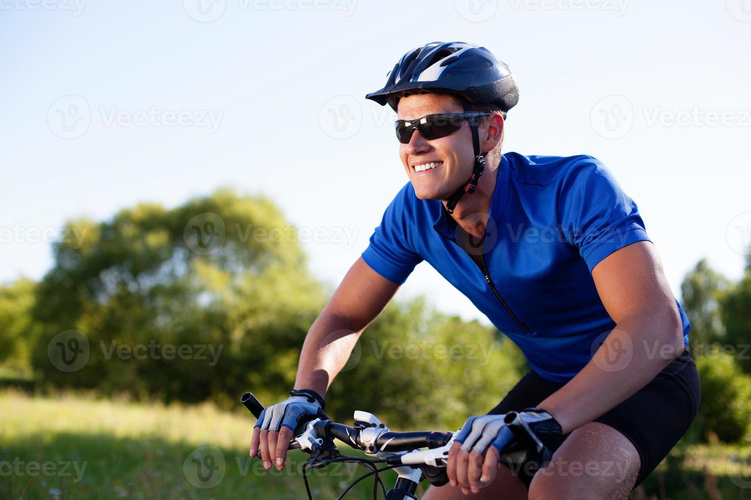 Mountainbiker riding bike photo