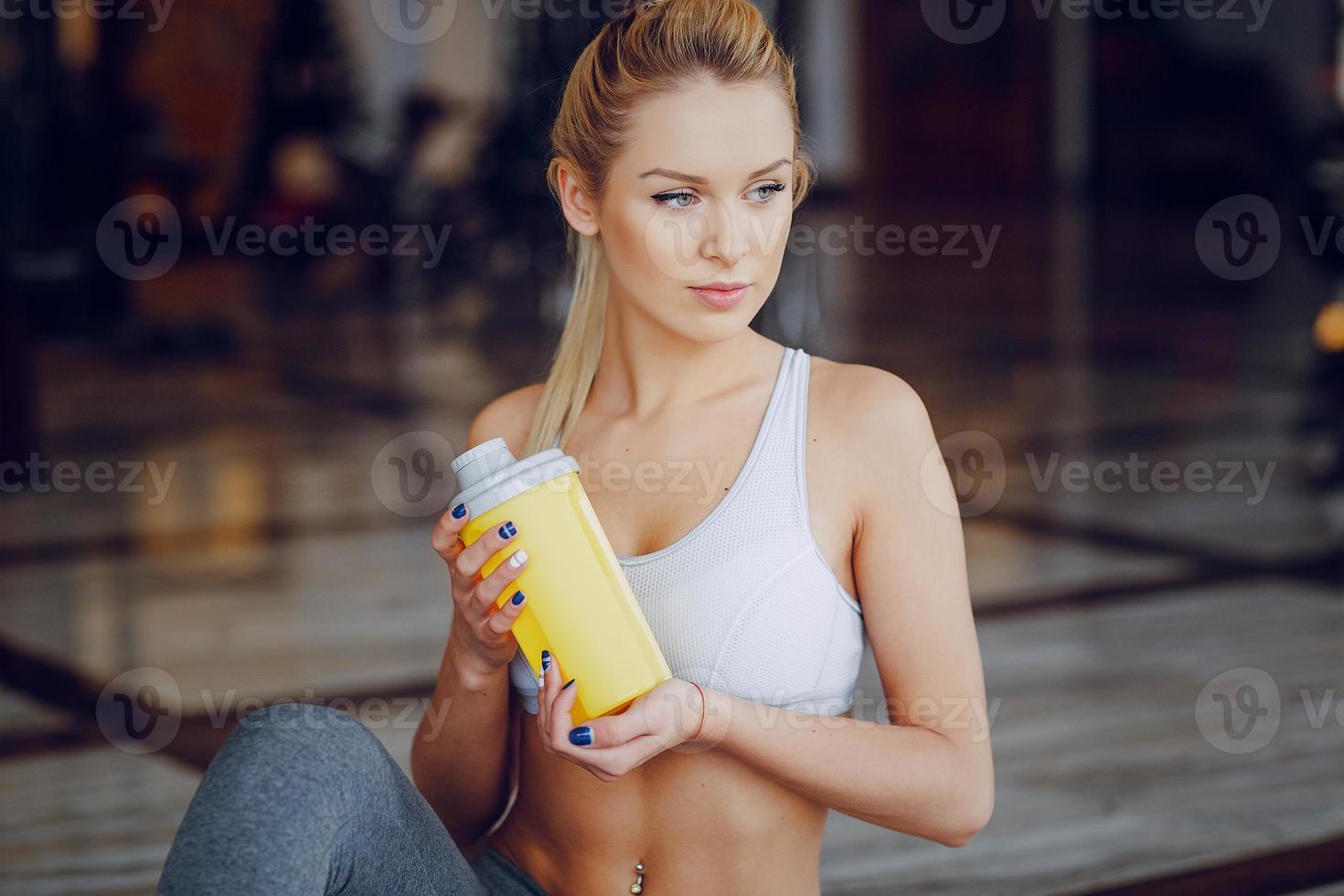 Beautiful blonde doing gym exercises photo