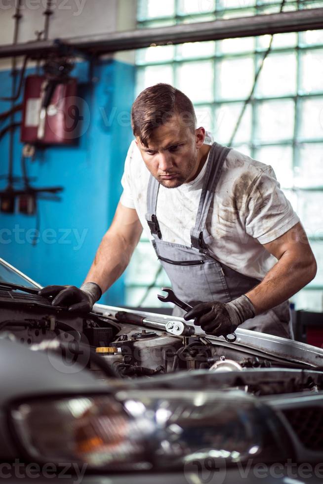 Car mechanic with wrench photo