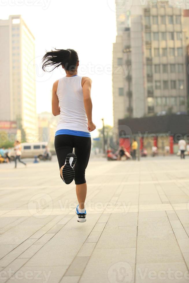 healthy lifestyle fitness sports woman  running on city road photo