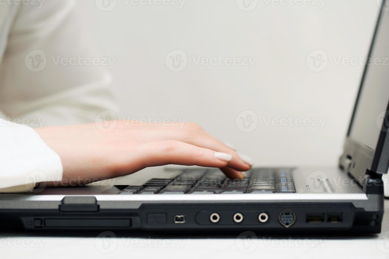 Female hands using laptop photo