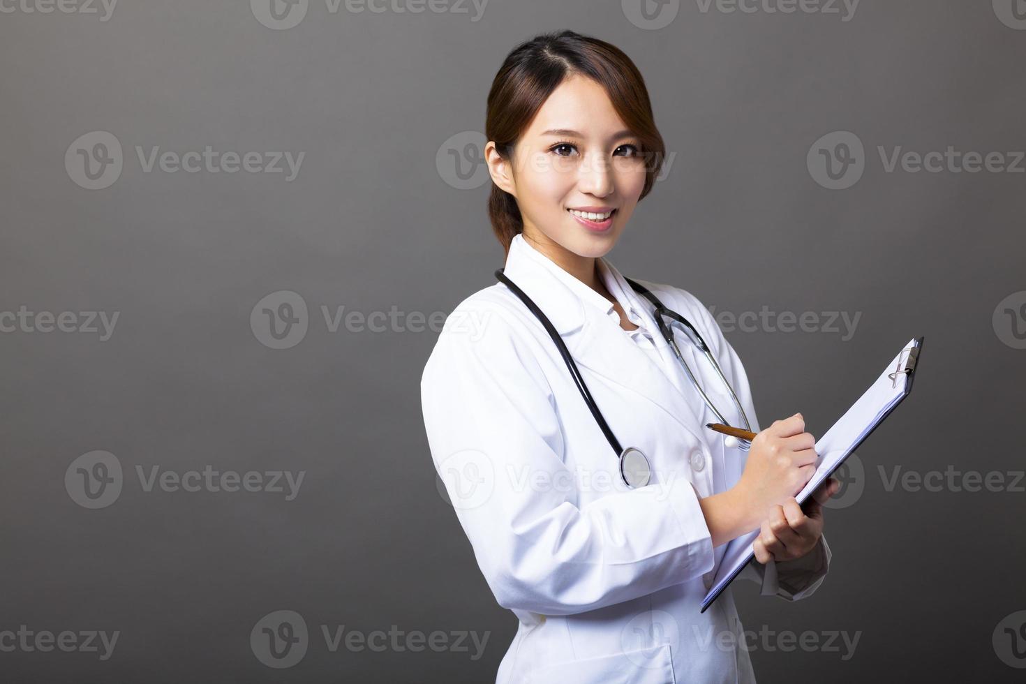 cheerful female doctor with clipboard photo