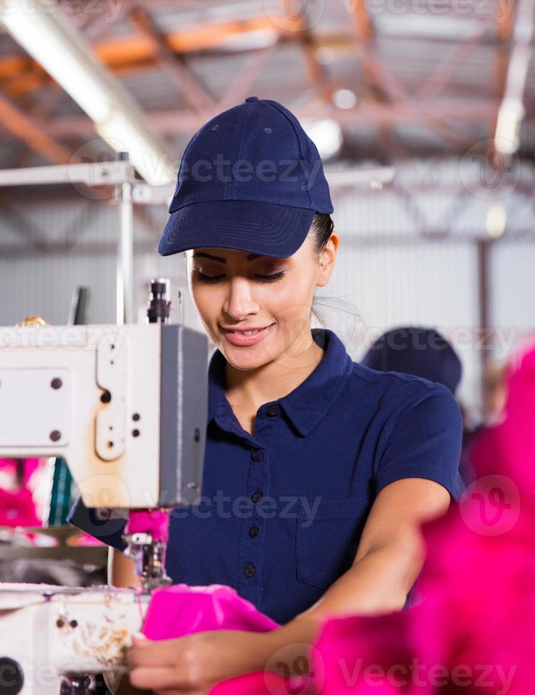 female factory worker sewing garment photo
