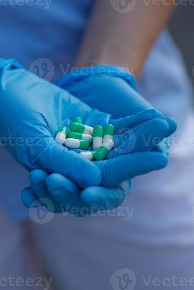 female doctor holding medicine capsules photo