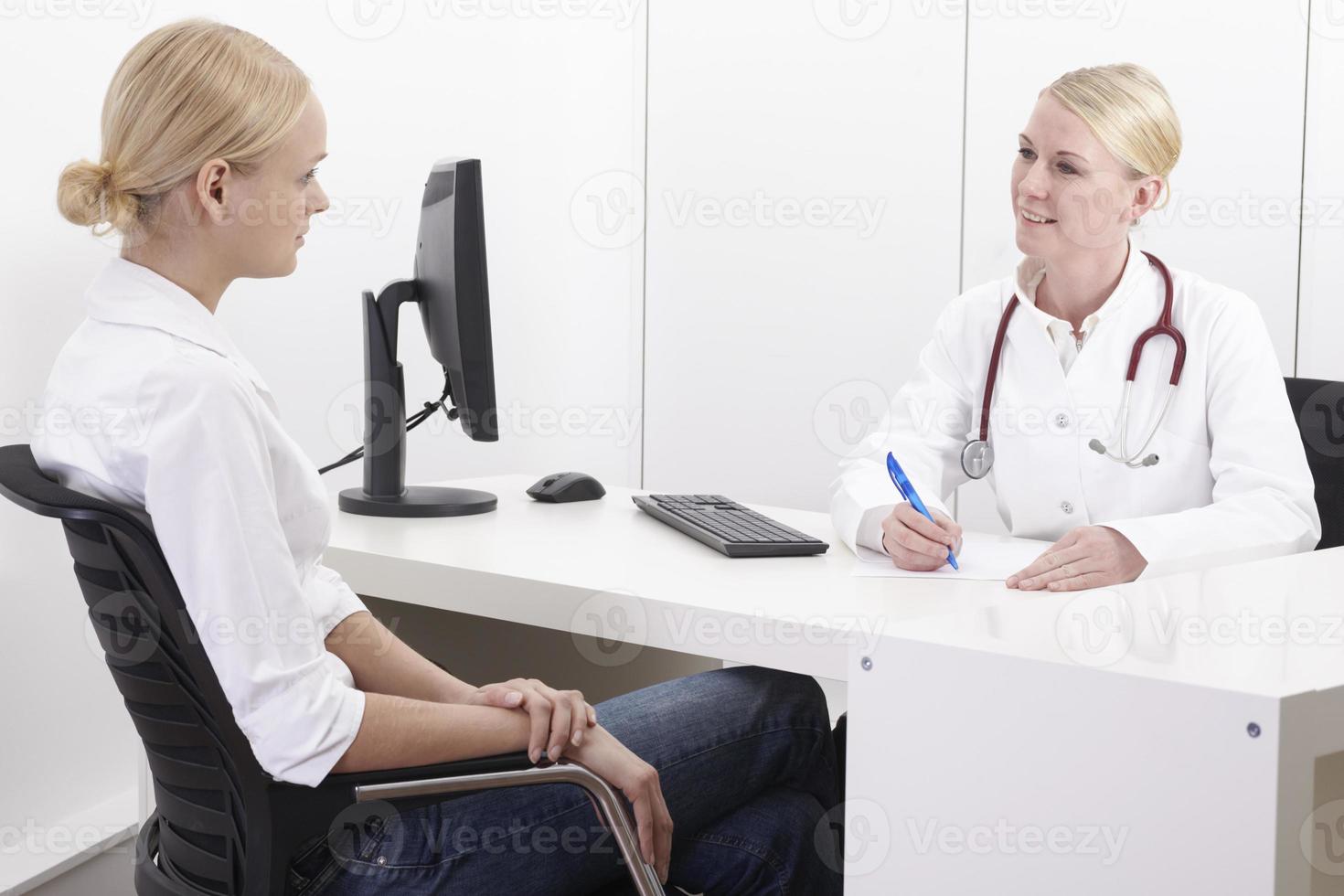 Female doctor talking with patient photo