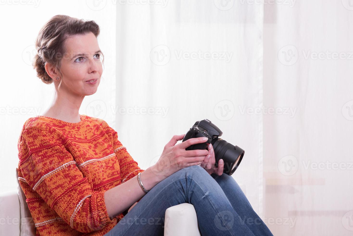 female Photographer sitting in armchair photo