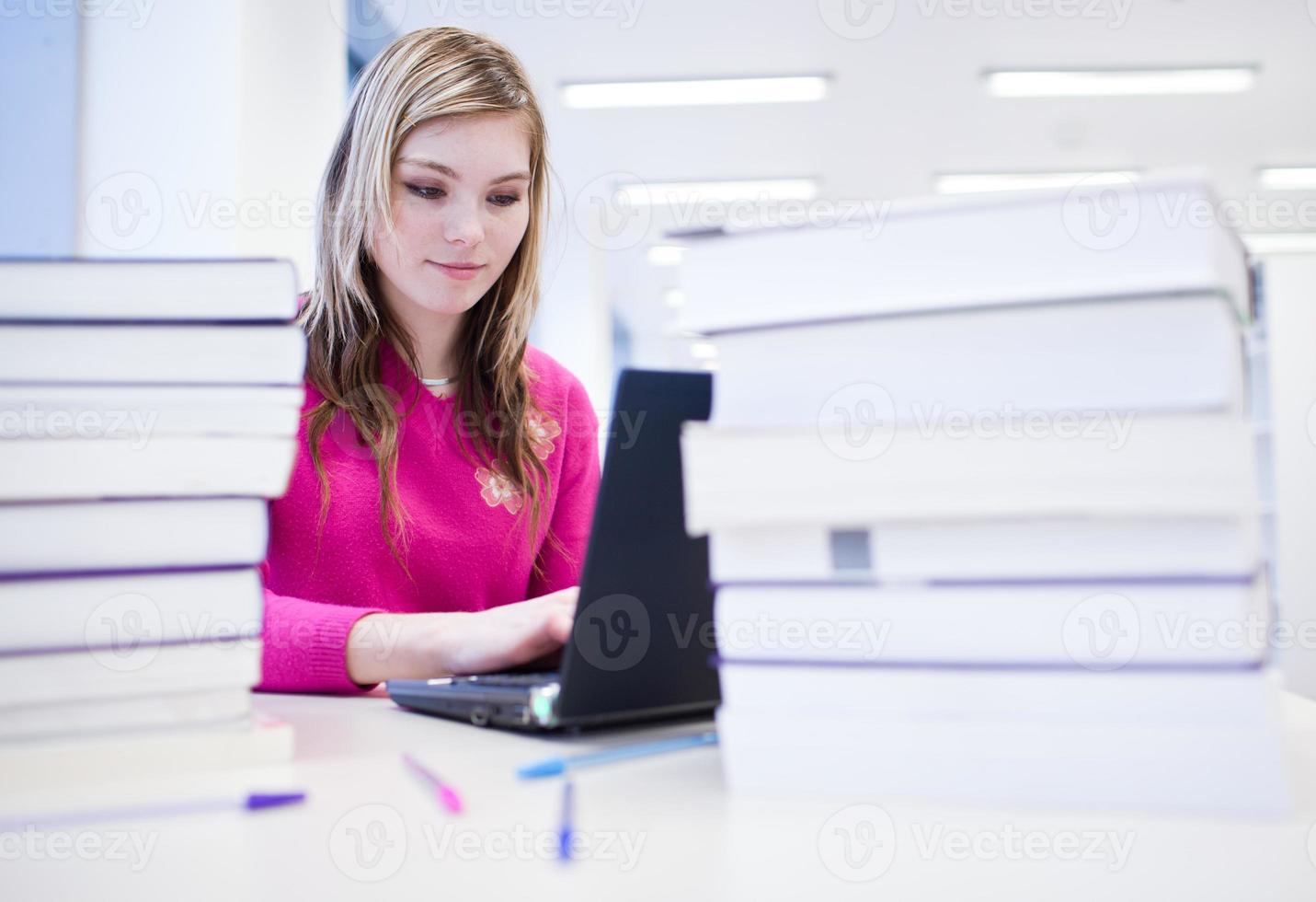 pretty, female student in library photo