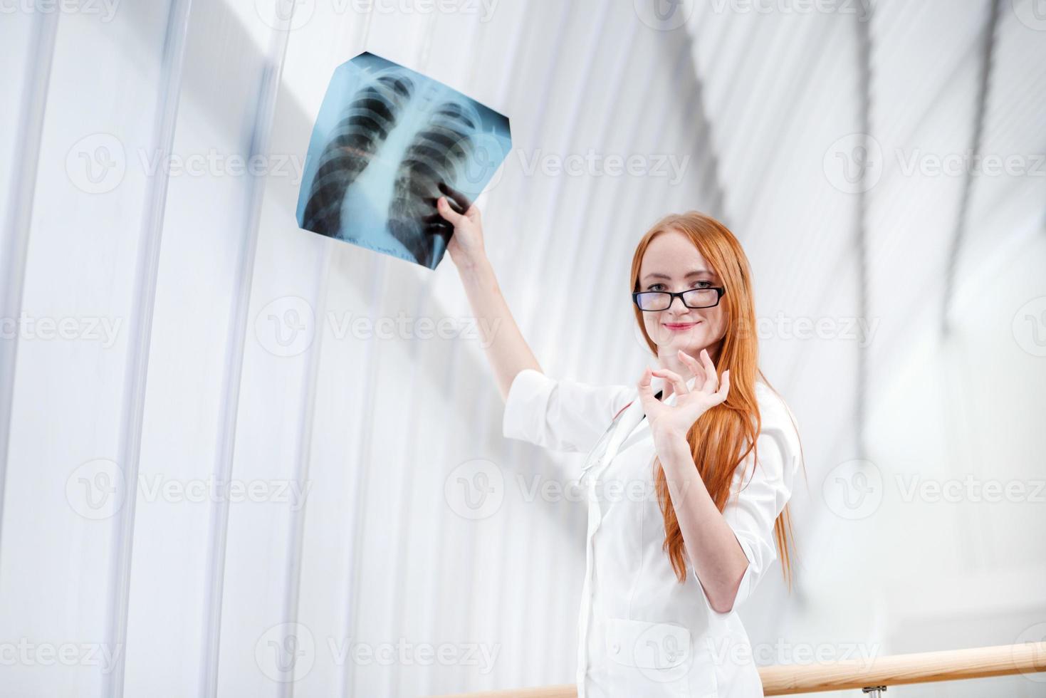 Female doctor examining an x-ray photo