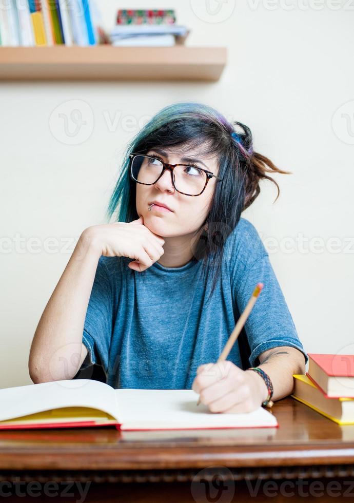 Young meditating female student with book photo