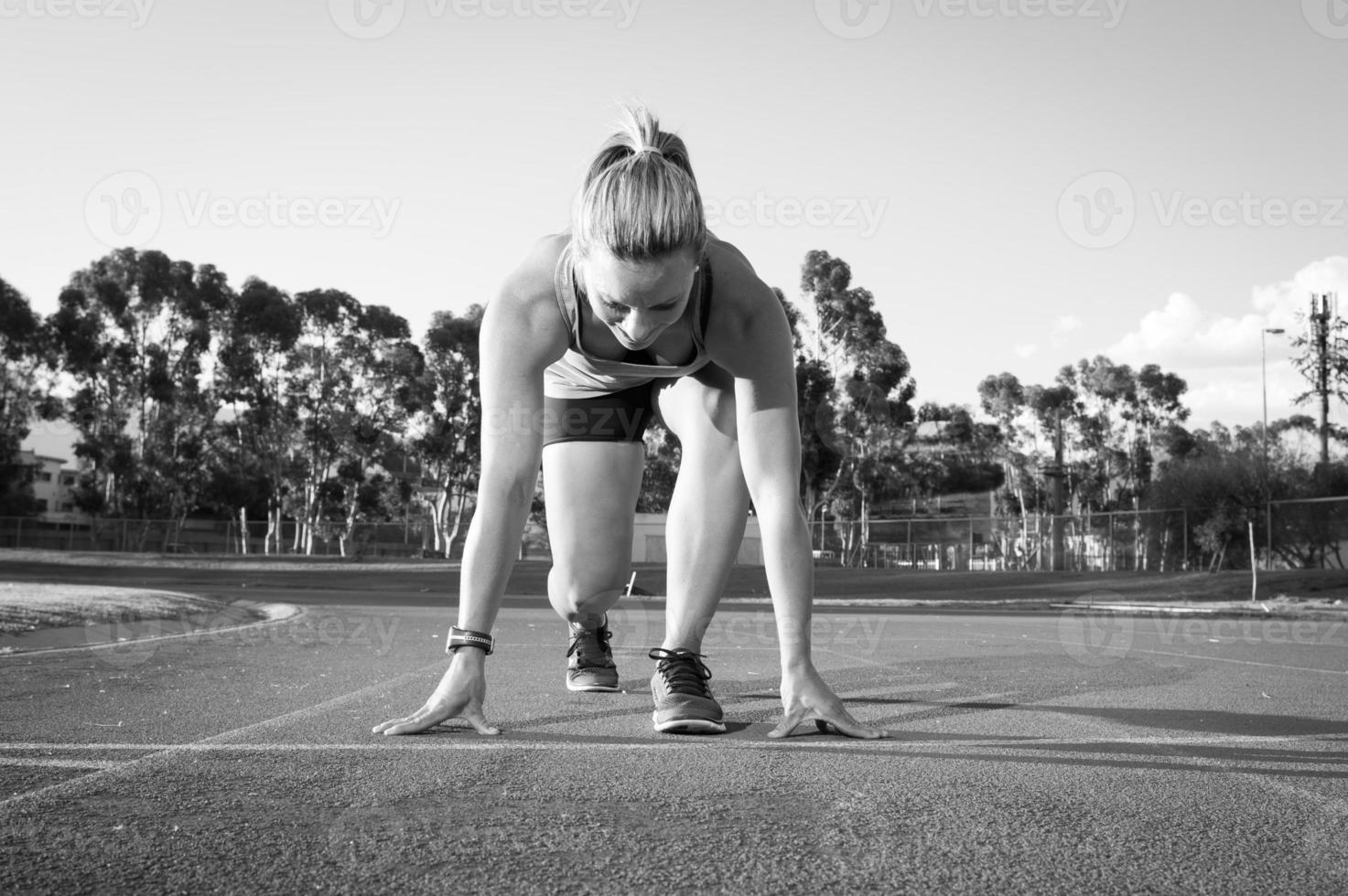 Female runner on an athletics track photo