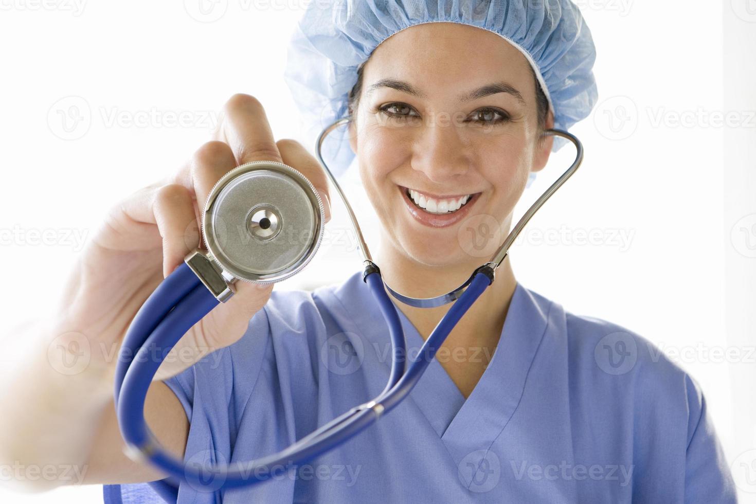 Female doctor with stethoscope, smiling, portrait photo
