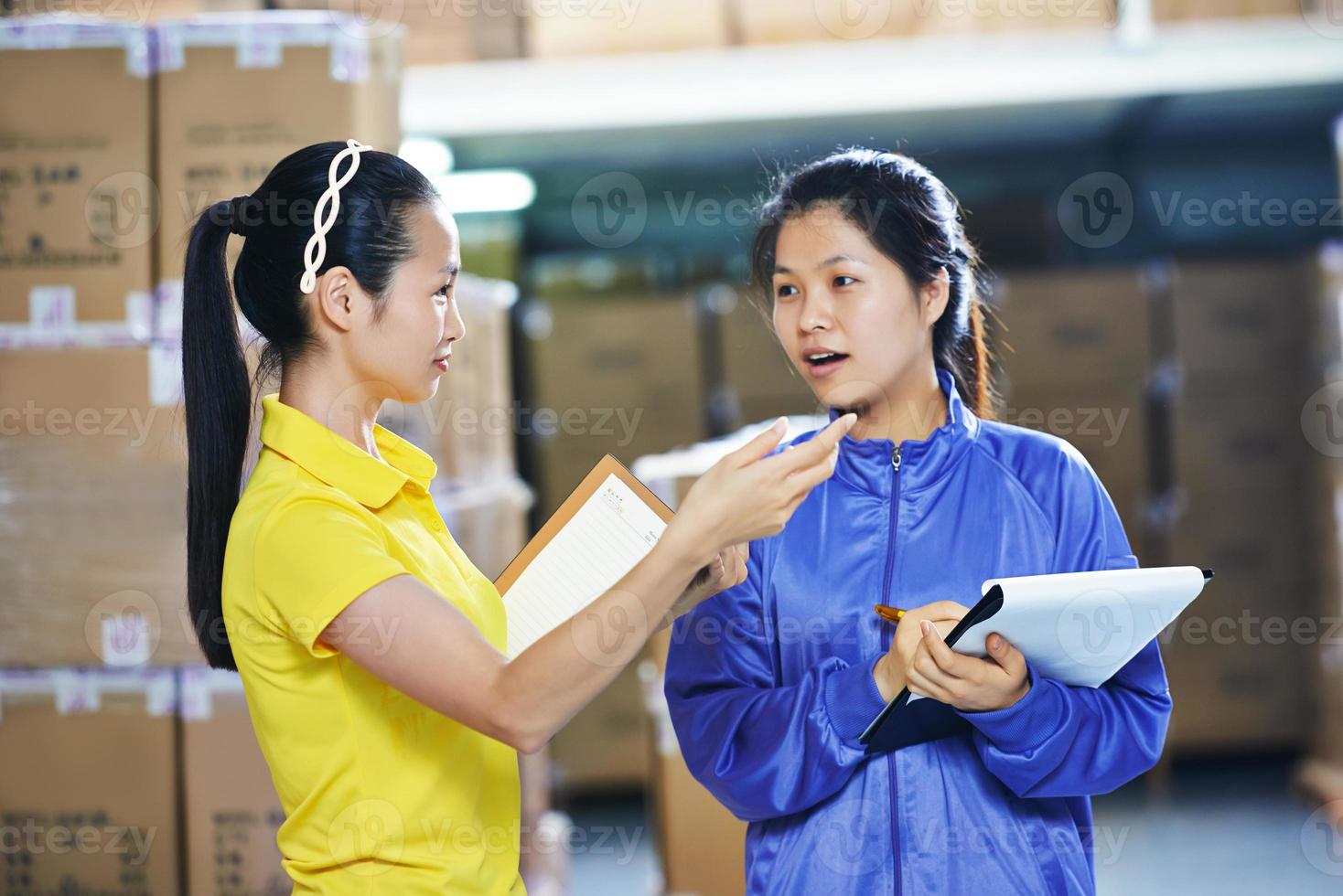 two chinese female workers in warehouse photo