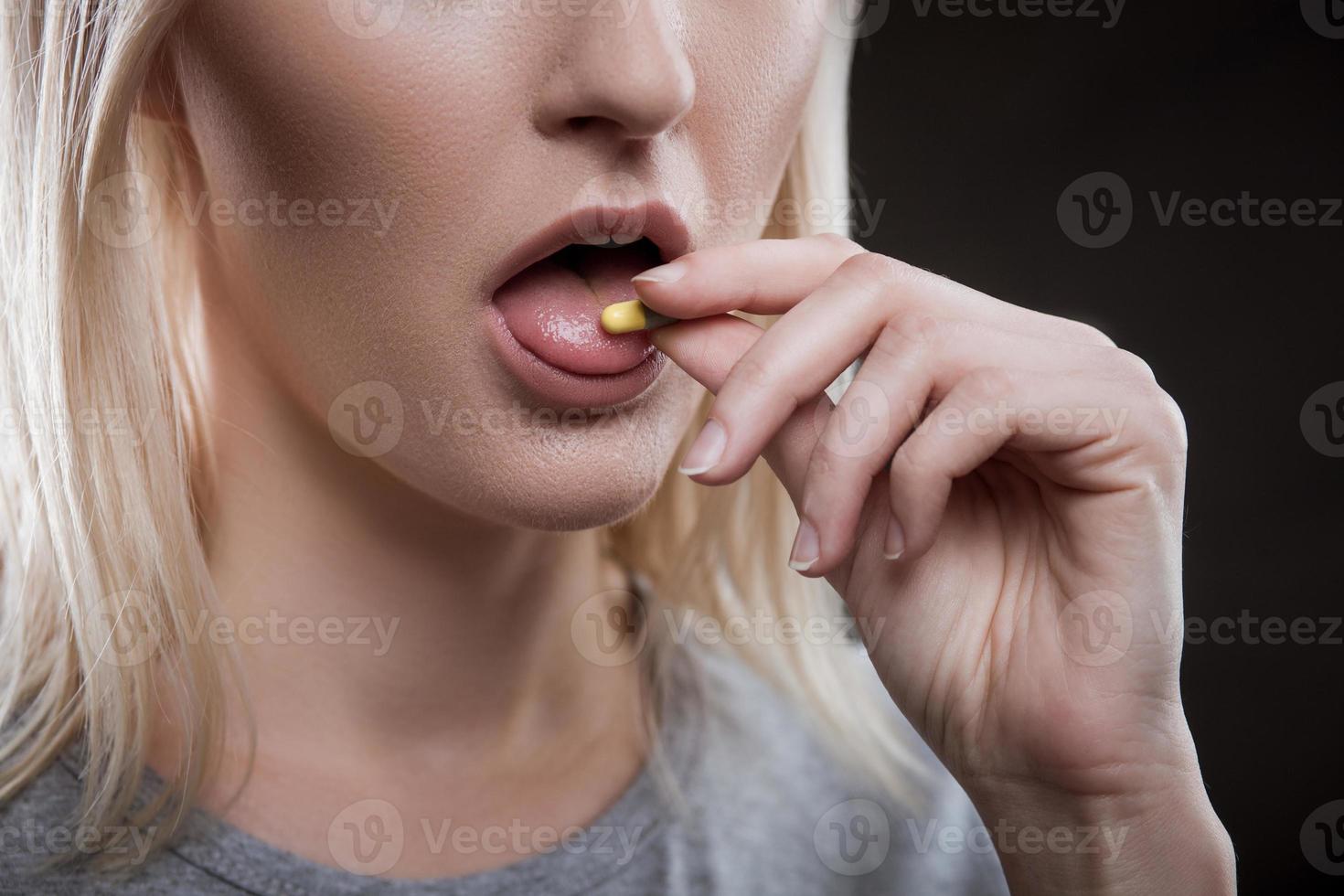 Depressed young female druggie is receiving ecstasy photo