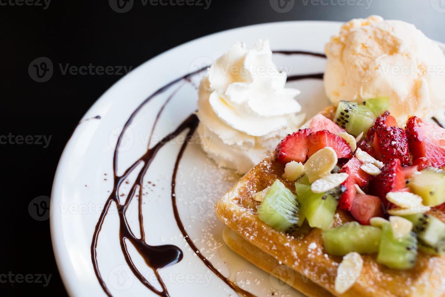 Waffles with fresh berries, whipped cream and ice cream photo