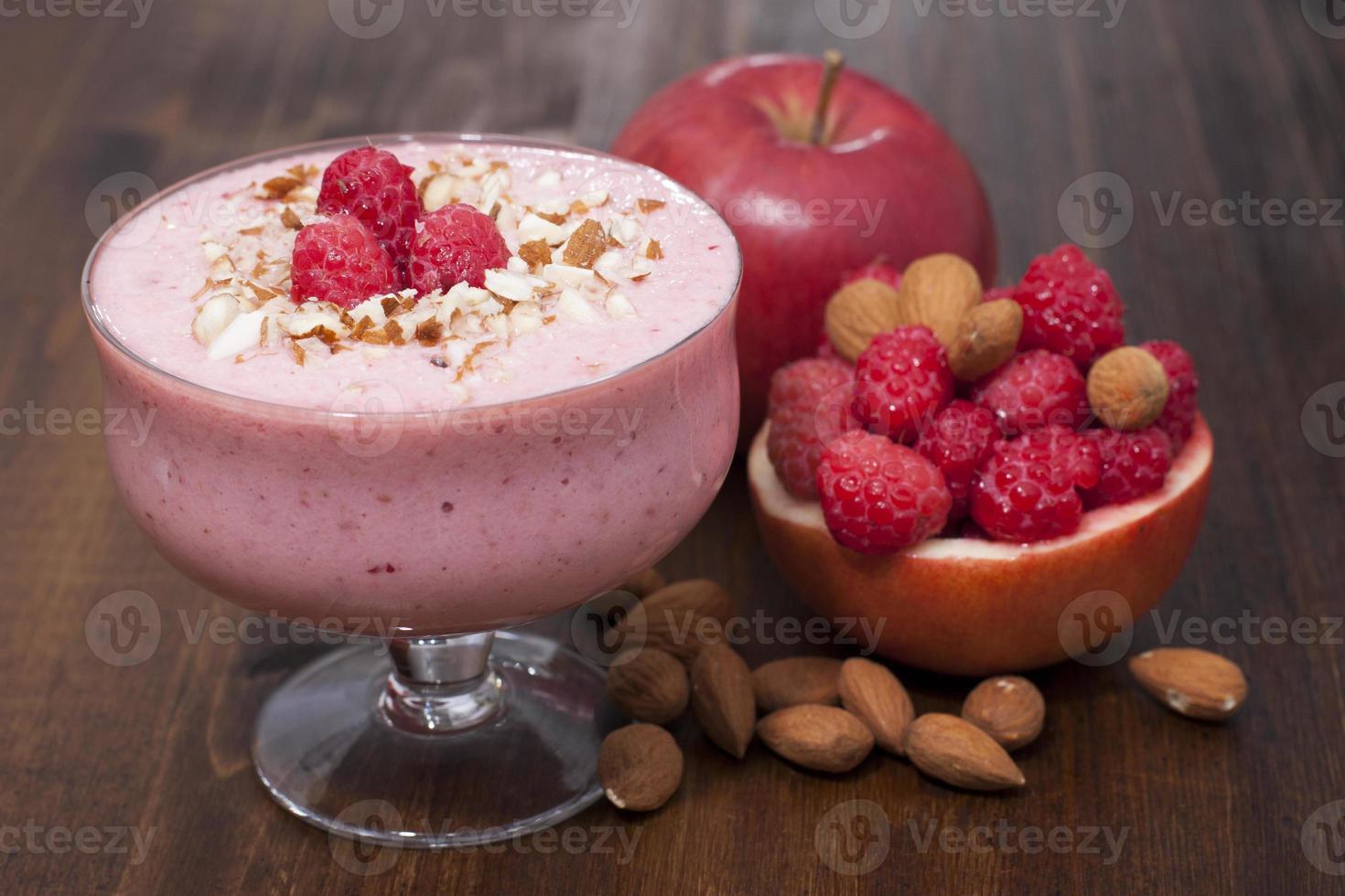 Cocktail of frozen raspberries, apple with nuts and yogurt. photo