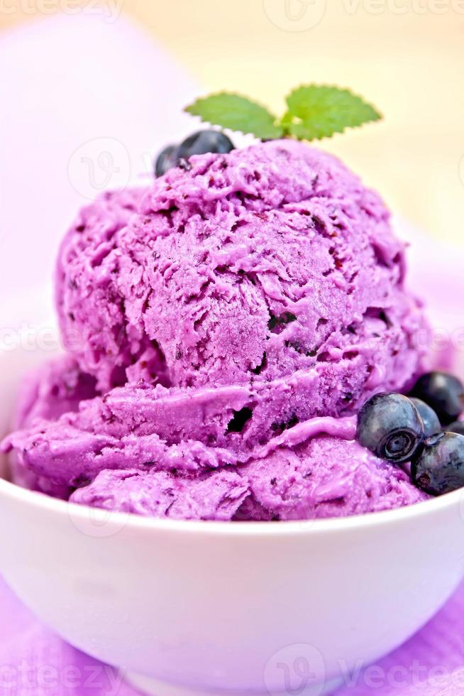 Ice cream blueberry with mint in bowl on napkin photo