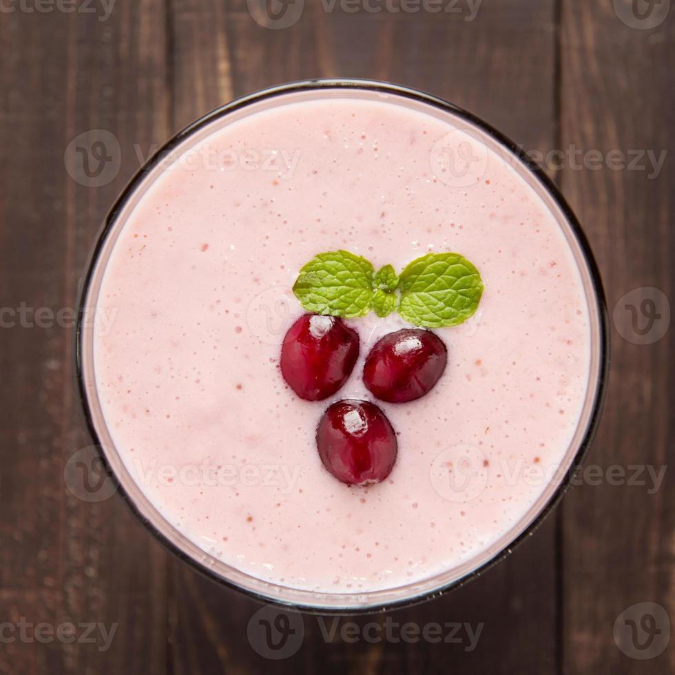 Cranberry fruit smoothie on wooden background, healthy eating. photo