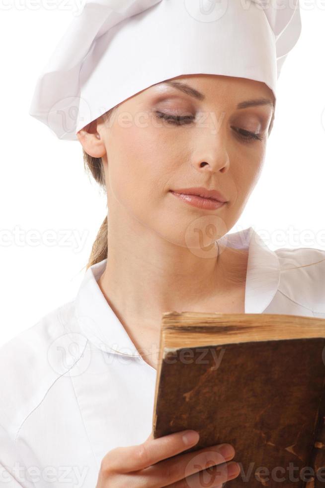 woman cook reading recipes book photo