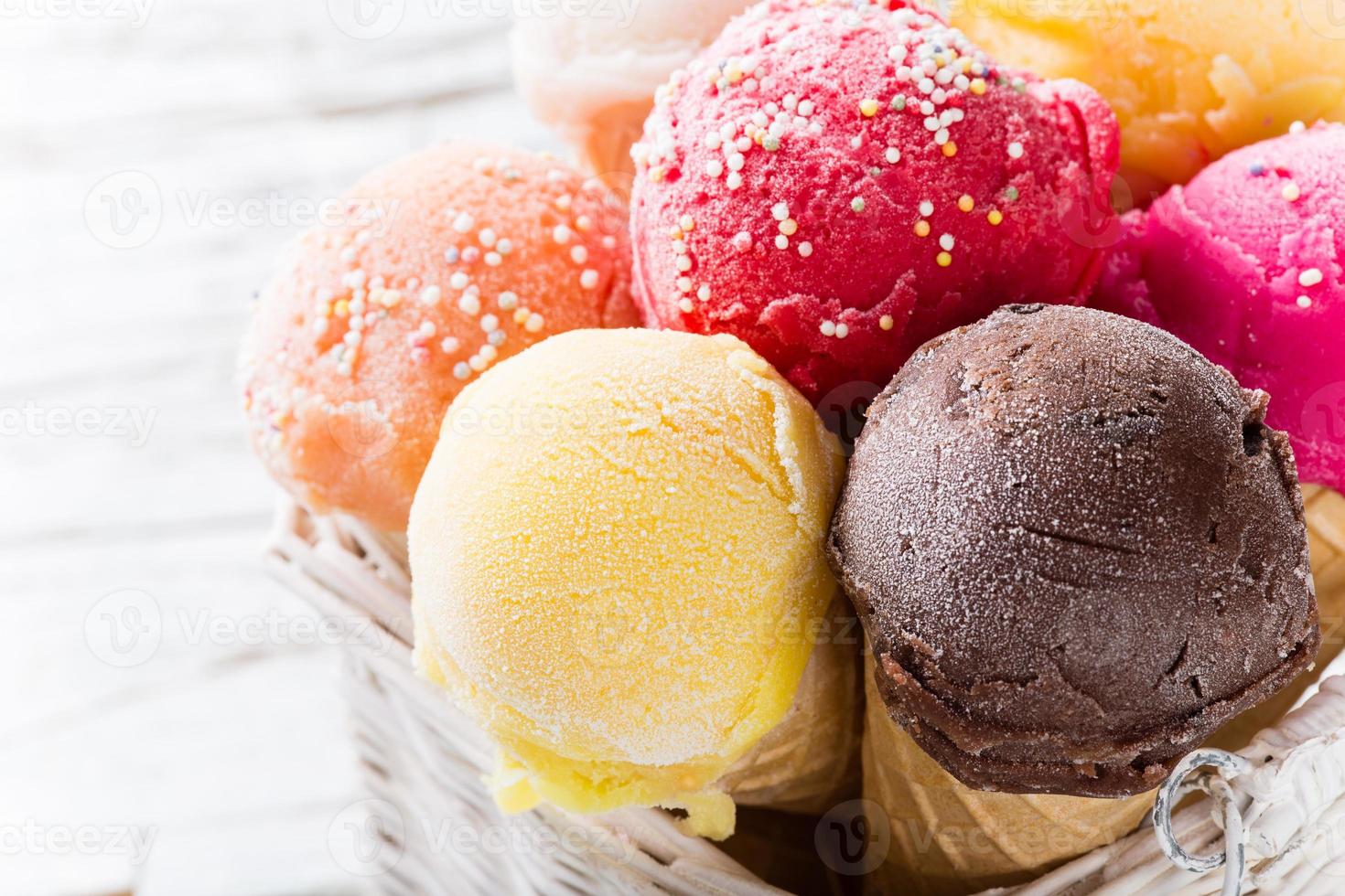Ice cream scoops on wooden table. photo