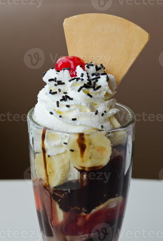 ice cream sundae with cherry and banana topping photo