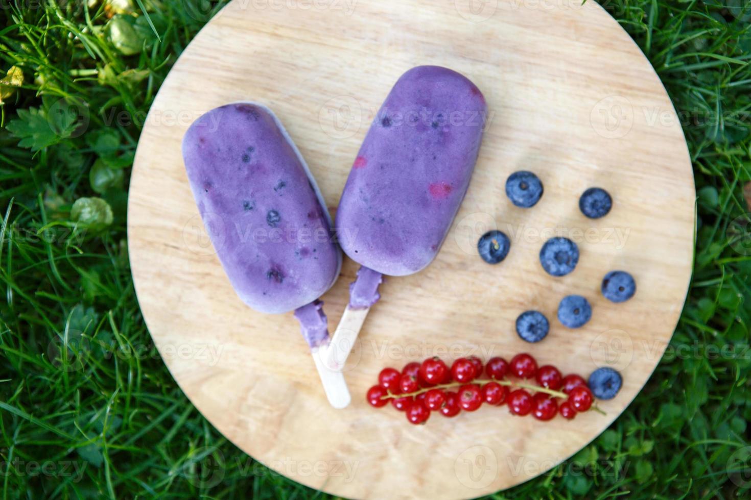 Homemade ice cream pops with different berries photo