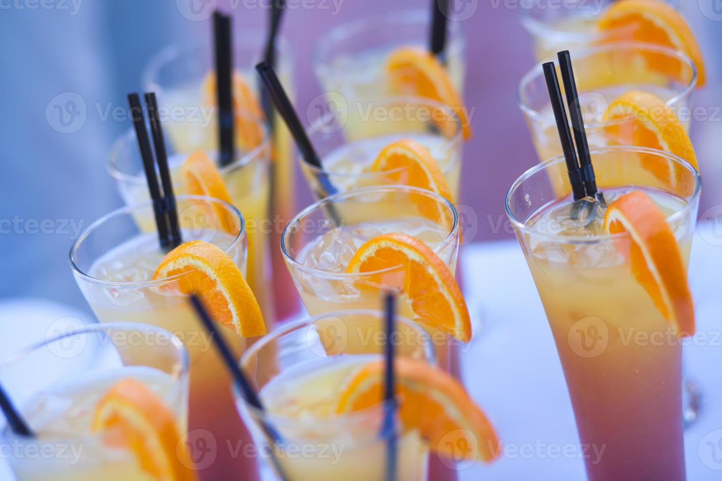 Line of different alcohol cocktails on event open-air night party photo