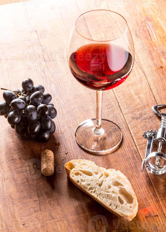 Red wine against wooden background photo