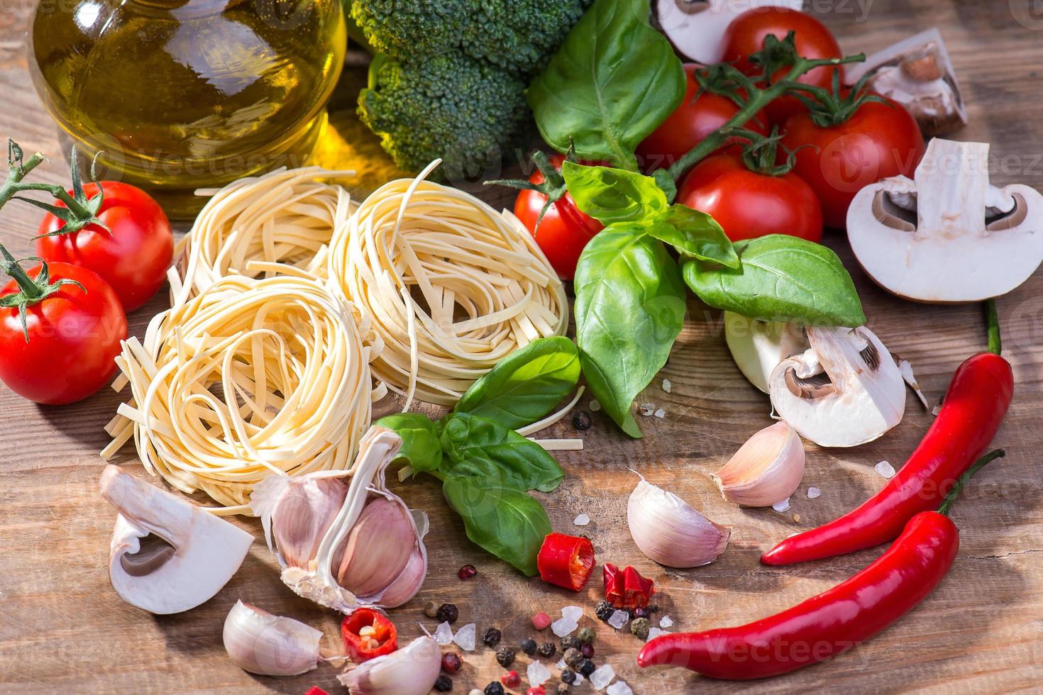 Pasta ingredients on a wood background photo